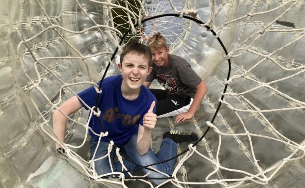 Two boys, members of NESS’s Young People's Sensory Service enjoy playing in a zorbing ‘bubble tunnel’.
