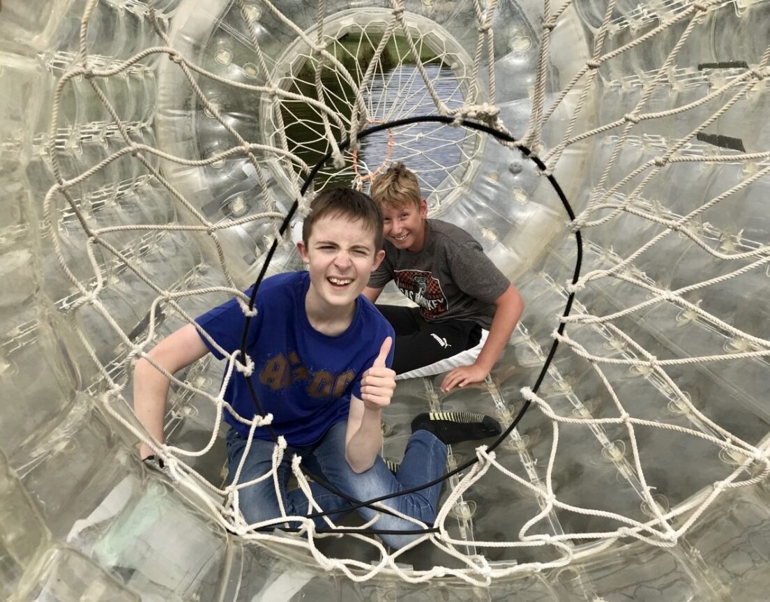 Two boys, members of NESS’s Young People's Sensory Service enjoy playing in a zorbing ‘bubble tunnel’.