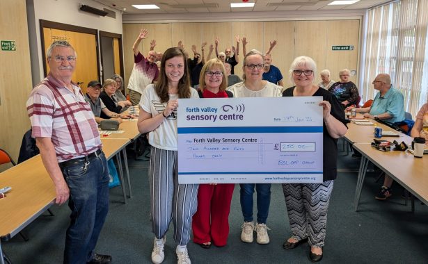 BSL OAP Group holding up large cheque for £250