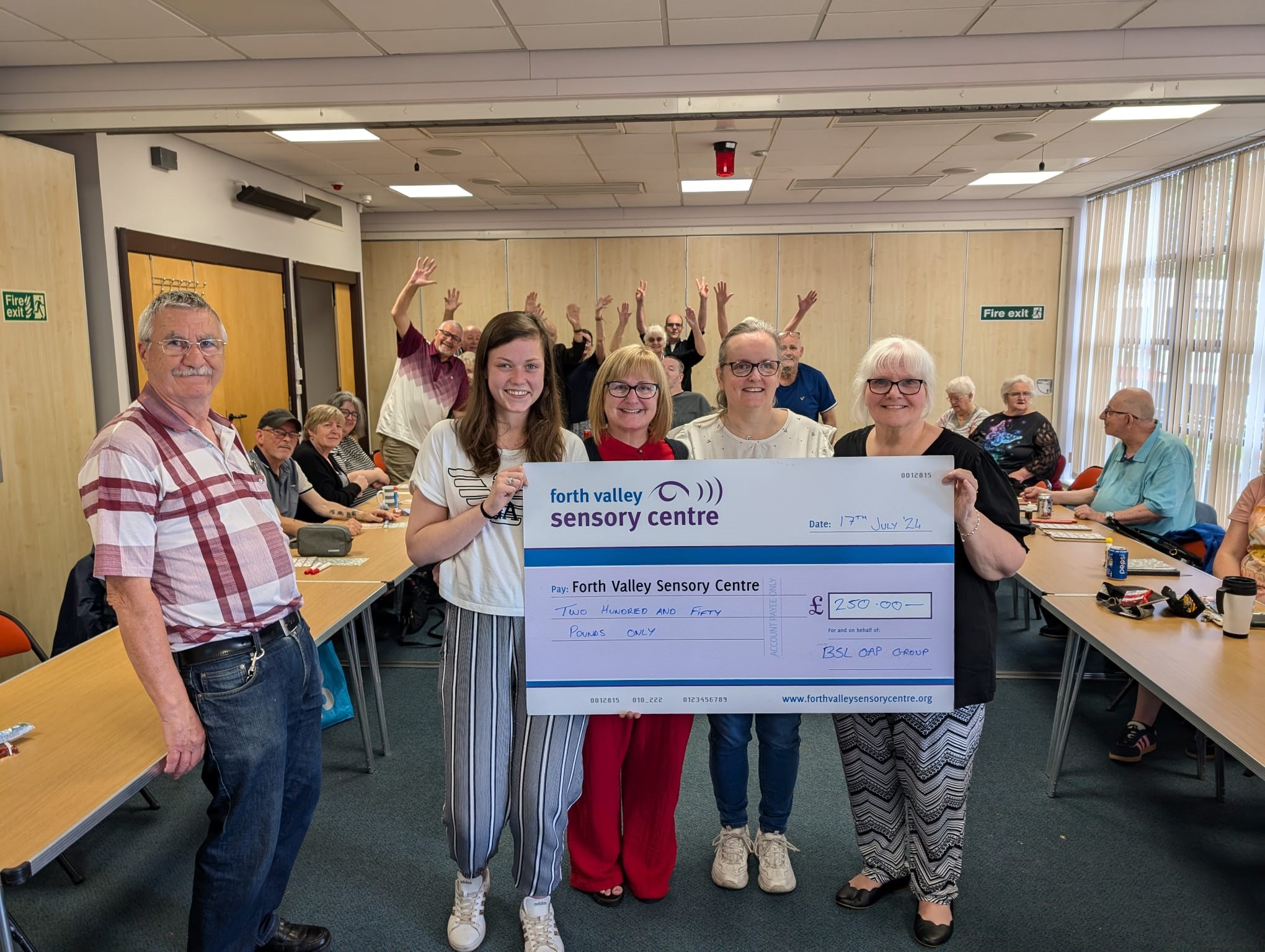 BSL OAP Group holding up large cheque for £250