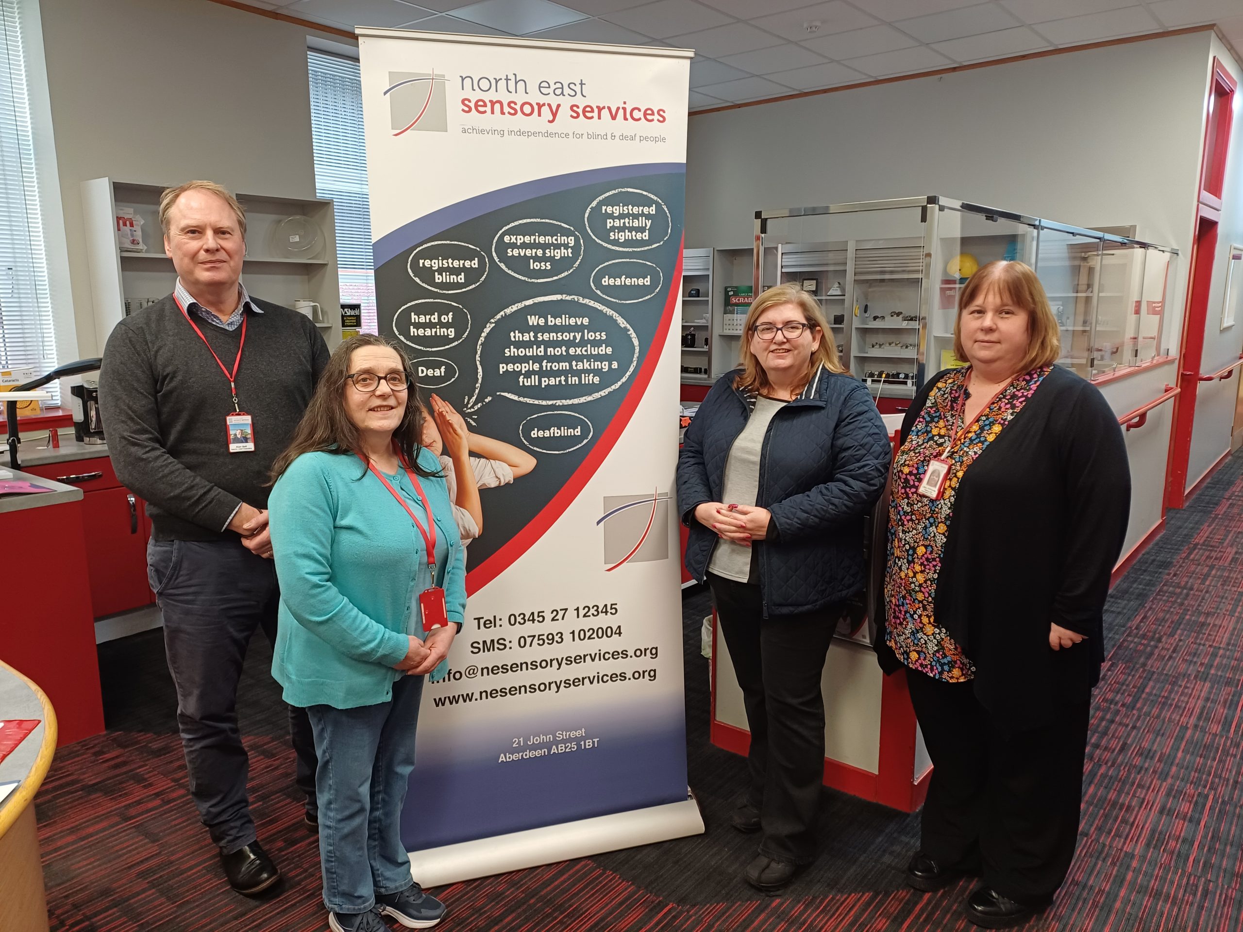 Left to right: Alan Bell, NESS added value services manager Sheila Ogden, Jackie Dunbar MSP, NESS training and information officer Libby Hillhouse standing beside a NESS banner.